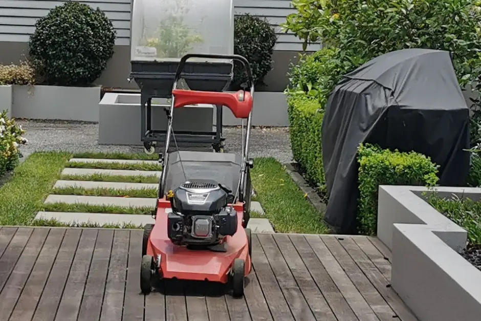 Lawn mowing equipment loaded on a trailer deck, ready for a mowing and garden maintenance job in Christchurch
